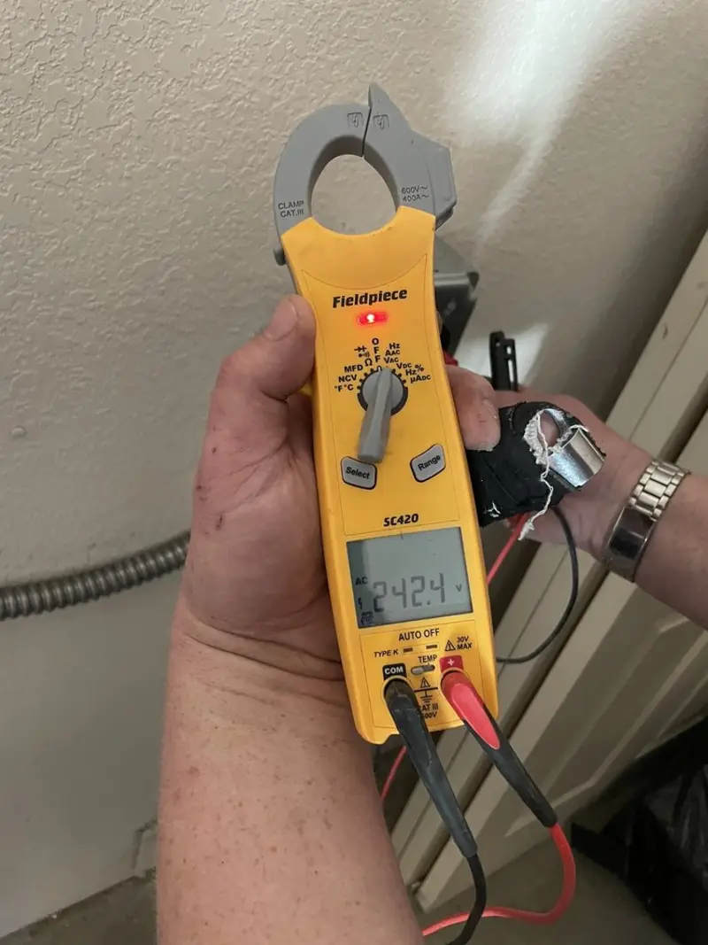 Voltage testing with clamp meter during Electrical Installation Services in St. Petersburg